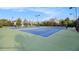 Well-maintained tennis courts with multiple courts and benches under sunny skies at 1865 Henley Way, Alpharetta, GA 30009
