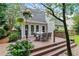 Cozy back deck with outdoor dining set and steps leading to a garden, perfect for relaxing and entertaining at 5355 Wyntree Ct, Peachtree Corners, GA 30071