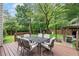 View of the back deck with outdoor seating, overlooking a beautifully landscaped and fenced backyard at 5355 Wyntree Ct, Peachtree Corners, GA 30071
