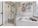 An ensuite bathroom features a glass enclosed shower and soaking tub at 5355 Wyntree Ct, Peachtree Corners, GA 30071