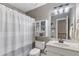 Bathroom with single sink vanity, toilet, and shower with striped curtain at 5355 Wyntree Ct, Peachtree Corners, GA 30071
