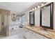 An ensuite bathroom offers dual sinks, granite counters, a separate shower, and a soaking tub at 5355 Wyntree Ct, Peachtree Corners, GA 30071