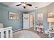 Bright and airy bedroom with blue walls, a ceiling fan, plush rug, and daybed at 5355 Wyntree Ct, Peachtree Corners, GA 30071