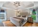 A primary bedroom features a trey ceiling, hardwood floors, and backyard views at 5355 Wyntree Ct, Peachtree Corners, GA 30071
