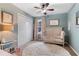 Light and airy bedroom with blue walls, a ceiling fan, plush rug, and daybed at 5355 Wyntree Ct, Peachtree Corners, GA 30071