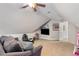 Large bonus room featuring comfortable seating, mounted tv and ceiling fan at 5355 Wyntree Ct, Peachtree Corners, GA 30071