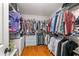 Walk-in closet with hardwood floors, wire shelving, and rods for ample storage and organization at 5355 Wyntree Ct, Peachtree Corners, GA 30071
