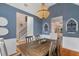 Chic dining area with a vaulted ceiling, modern lighting, and an open view to the adjacent staircase at 5355 Wyntree Ct, Peachtree Corners, GA 30071