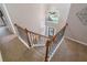 Foyer with a staircase with oak handrail overlooking the front door and neighborhood views at 5355 Wyntree Ct, Peachtree Corners, GA 30071