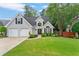 Charming two-story home with a manicured lawn, two-car garage, and lovely curb appeal at 5355 Wyntree Ct, Peachtree Corners, GA 30071