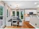 A bright eat-in kitchen boasts a farmhouse table, white cabinetry, and stainless steel appliances at 5355 Wyntree Ct, Peachtree Corners, GA 30071