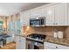 Well-appointed kitchen with a gas range, granite counters, and a breakfast nook area at 5355 Wyntree Ct, Peachtree Corners, GA 30071