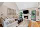 The comfortable living room features a fireplace, a high ceiling, and backyard access at 5355 Wyntree Ct, Peachtree Corners, GA 30071