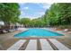 Community pool offers a refreshing escape with ample lounge chairs and umbrellas for relaxation at 5355 Wyntree Ct, Peachtree Corners, GA 30071