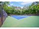 Enjoy a game on this well-maintained outdoor tennis court within a lush, wooded community at 5355 Wyntree Ct, Peachtree Corners, GA 30071