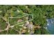 Aerial view of a secluded property with a private drive, pool, and lake access at 7875 Robin Rd, Cumming, GA 30041