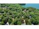 Panoramic aerial view of a lakefront residence encompassed by lush greenery, emphasizing its natural setting at 7875 Robin Rd, Cumming, GA 30041