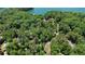 High-angle view of a home surrounded by trees and a lake, highlighting the property's natural beauty at 7875 Robin Rd, Cumming, GA 30041