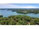 Breathtaking aerial shot showcases a lakefront home nestled among a dense forest with a scenic lake view at 7875 Robin Rd, Cumming, GA 30041