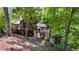 Elevated exterior view showing lower level patio and lush green surroundings at 7875 Robin Rd, Cumming, GA 30041