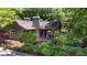 View of the back exterior and deck overlooking the landscaped yard at 7875 Robin Rd, Cumming, GA 30041