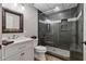 Contemporary bathroom features a glass shower, modern vanity, and neutral tile at 7875 Robin Rd, Cumming, GA 30041