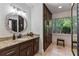 Bathroom features granite counters, decorative mirror, and custom built in wardrobe at 7875 Robin Rd, Cumming, GA 30041