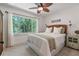 Comfortable bedroom with a large window offering a view of the surrounding nature at 7875 Robin Rd, Cumming, GA 30041