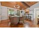 Dining area next to an eat-in kitchen with wood floors and seamless access to the outdoors at 7875 Robin Rd, Cumming, GA 30041