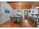Dining area in view of the kitchen, featuring wood floors and natural light at 7875 Robin Rd, Cumming, GA 30041