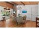 Open dining area features wood floors, stone fireplace, and seamless access to the outdoors at 7875 Robin Rd, Cumming, GA 30041
