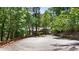 Long paved driveway leading to a charming home surrounded by mature trees at 7875 Robin Rd, Cumming, GA 30041