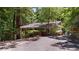 A quaint one story home featuring a well-maintained yard and mature trees at 7875 Robin Rd, Cumming, GA 30041