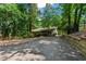 Charming home nestled among trees with a quaint front yard and private driveway at 7875 Robin Rd, Cumming, GA 30041