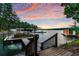 Scenic view of the lake with a boat dock and a covered boat at 7875 Robin Rd, Cumming, GA 30041