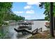 Scenic view of lake with multiple docks, boats, and wooded surroundings at 7875 Robin Rd, Cumming, GA 30041