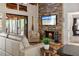 Beautiful living room featuring a stone fireplace, hardwood floors, and access to a screened in porch at 7875 Robin Rd, Cumming, GA 30041