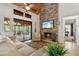 Cozy living room with stone fireplace, vaulted ceilings, and access to screened porch at 7875 Robin Rd, Cumming, GA 30041