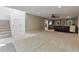 Spacious carpeted living room is well-lit with a large staircase and an entertainment center at 7875 Robin Rd, Cumming, GA 30041
