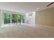Living room with sliding glass doors leading to a deck with backyard views at 7875 Robin Rd, Cumming, GA 30041