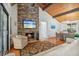 Cozy living room with vaulted ceilings, stone fireplace, and an open concept dining area at 7875 Robin Rd, Cumming, GA 30041