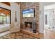 Attractive living room featuring a stone fireplace, hardwood floors, and access to outdoor spaces at 7875 Robin Rd, Cumming, GA 30041