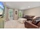 Well-lit living room boasts a leather couch, large windows, and built in cabinets at 7875 Robin Rd, Cumming, GA 30041