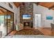 Inviting living room features a stone fireplace, hardwood floors, and access to an outdoor deck at 7875 Robin Rd, Cumming, GA 30041