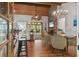 Open concept living space with stone fireplace, wood ceiling, and access to outdoor living at 7875 Robin Rd, Cumming, GA 30041