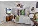 Stylish bedroom featuring neutral tones, a mounted TV, and access to a private outdoor balcony with beautiful views at 7875 Robin Rd, Cumming, GA 30041
