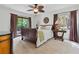 Comfortable main bedroom with a ceiling fan, a cozy bed, and access to a private outdoor balcony at 7875 Robin Rd, Cumming, GA 30041