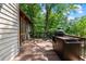 Outdoor grill and BBQ station on a wood deck surrounded by mature trees and natural landscaping at 7875 Robin Rd, Cumming, GA 30041