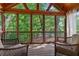 Comfortable screened porch with ample seating and serene views of the surrounding trees and nature at 7875 Robin Rd, Cumming, GA 30041