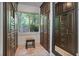 Spacious walk-in closet boasts custom built-in wardrobe with a great view of the yard at 7875 Robin Rd, Cumming, GA 30041